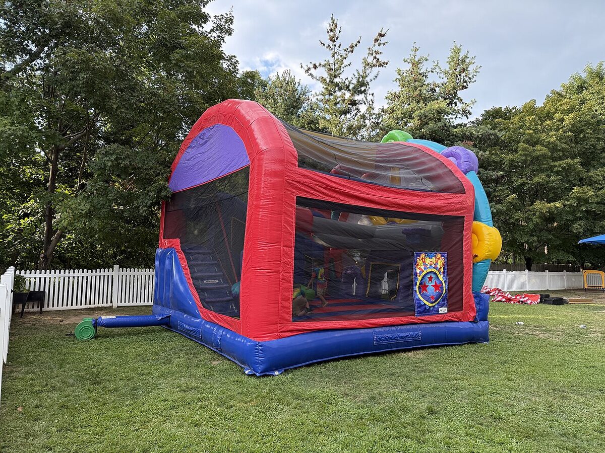 A castle bounce house set up on a lawn